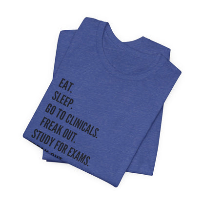 Nursing Student Tee — “Eat. Sleep. Go to Clinicals. Freak Out. Study for Exams. Freak Out. Slay. Repeat.”