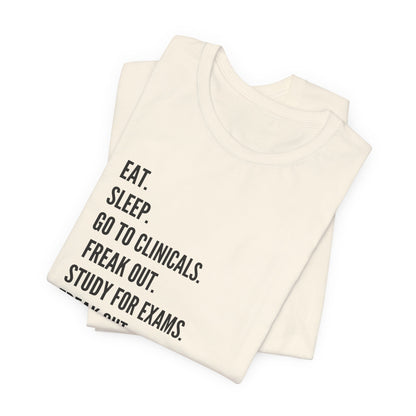 Nursing Student Tee — “Eat. Sleep. Go to Clinicals. Freak Out. Study for Exams. Freak Out. Slay. Repeat.”