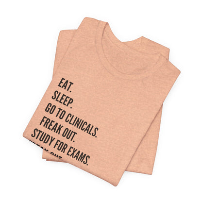 Nursing Student Tee — “Eat. Sleep. Go to Clinicals. Freak Out. Study for Exams. Freak Out. Slay. Repeat.”