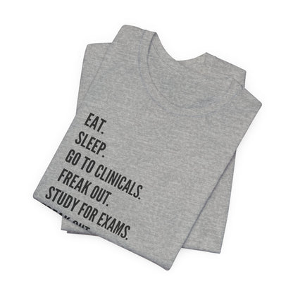 Nursing Student Tee — “Eat. Sleep. Go to Clinicals. Freak Out. Study for Exams. Freak Out. Slay. Repeat.”