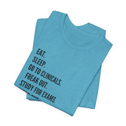 Nursing Student Tee — “Eat. Sleep. Go to Clinicals. Freak Out. Study for Exams. Freak Out. Slay. Repeat.”