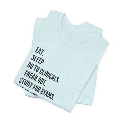 Nursing Student Tee — “Eat. Sleep. Go to Clinicals. Freak Out. Study for Exams. Freak Out. Slay. Repeat.”