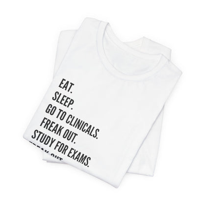 Nursing Student Tee — “Eat. Sleep. Go to Clinicals. Freak Out. Study for Exams. Freak Out. Slay. Repeat.”