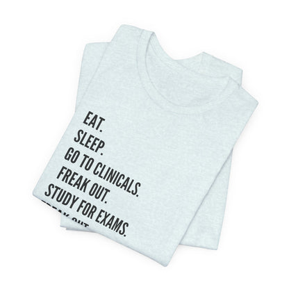 Nursing Student Tee — “Eat. Sleep. Go to Clinicals. Freak Out. Study for Exams. Freak Out. Slay. Repeat.”